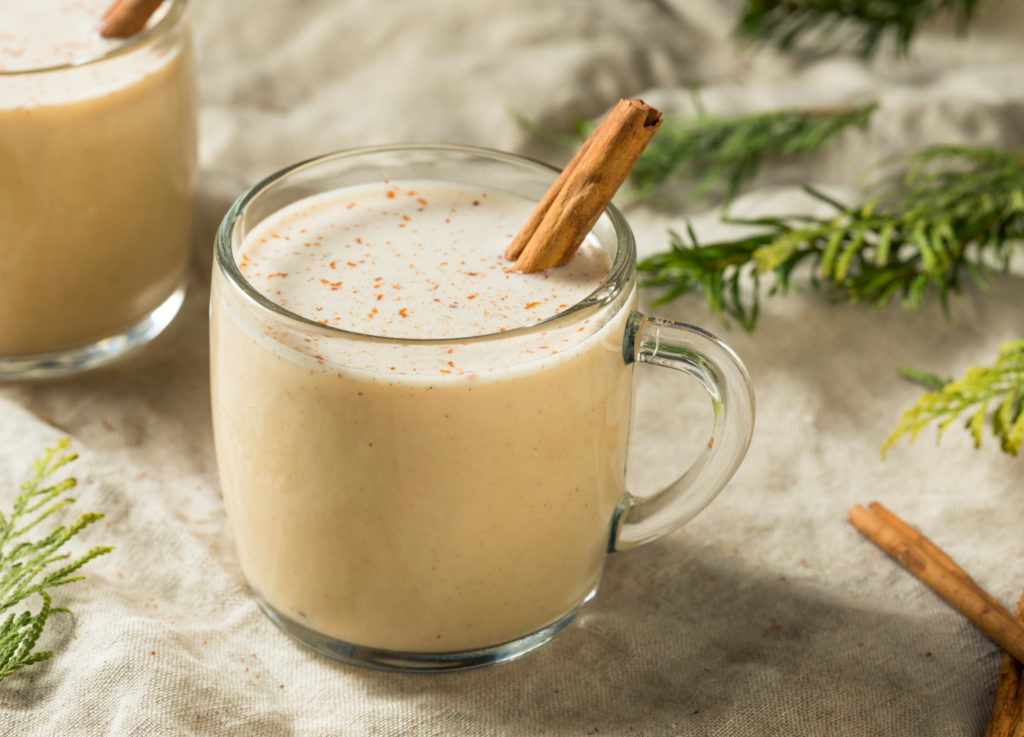 eggnog in cup with cinnamon stick